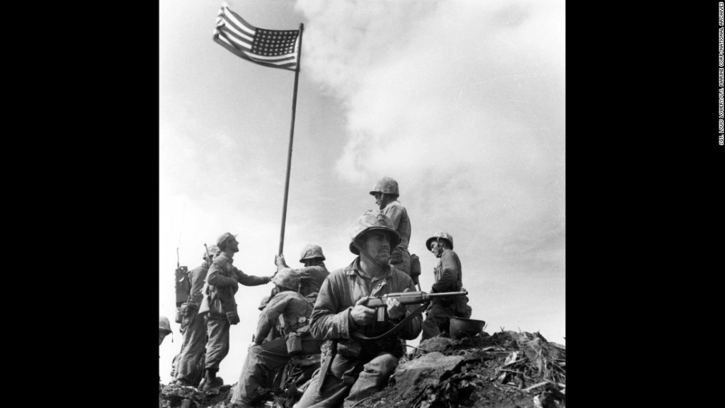 The first flag-raising, photographed by Marine Sgt. Louis Lowery